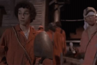 A Man With A Bandana On His Head Talks To Another Man With The Words Smaller Shovel Written Below Them GIF