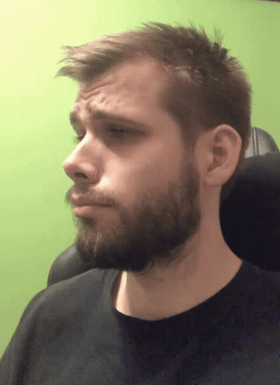 A Man With A Beard And A Black Shirt Is Making A Face GIF