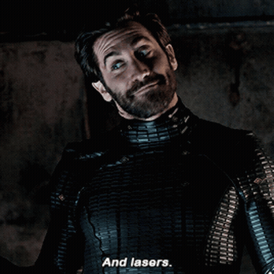 A Man With A Beard And A Black Suit Says And Lasers GIF