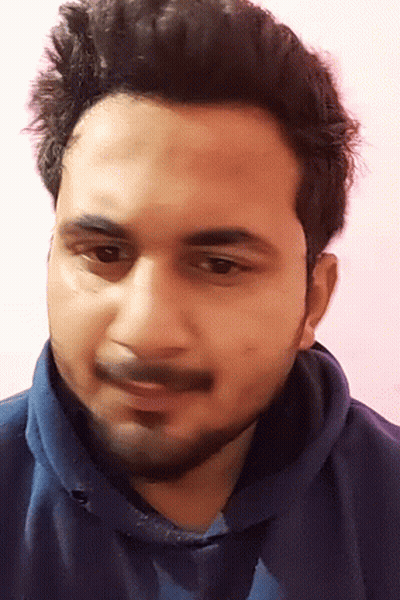A Man With A Beard And A Blue Shirt Is Smiling GIF