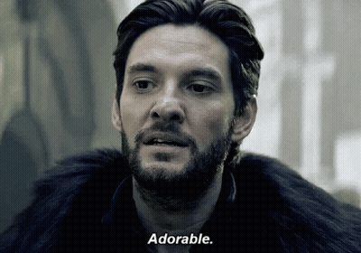 A Man With A Beard And A Fur Coat Says Adorable GIF