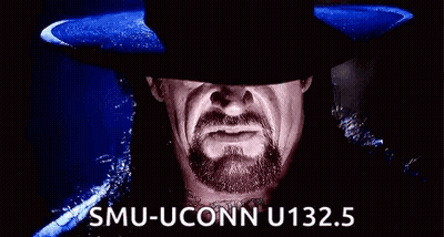 A Man With A Beard And A Hat Is Making A Funny Face And Saying Smu-Uconn U132.5 . GIF