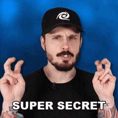 A Man With A Beard And A Hat Is Making A Super Secret Gesture With His Fingers . GIF