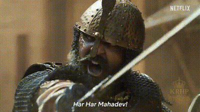 A Man With A Beard And A Helmet Is Holding A Sword And Shouting . GIF