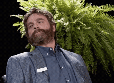 A Man With A Beard And A Name Tag On His Pocket GIF