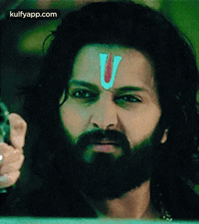 A Man With A Beard And A Red Letter V On His Forehead . GIF