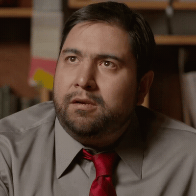 A Man With A Beard And A Red Tie Looks Surprised GIF