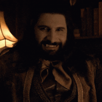 A Man With A Beard And A Ring On His Finger Is Smiling GIF