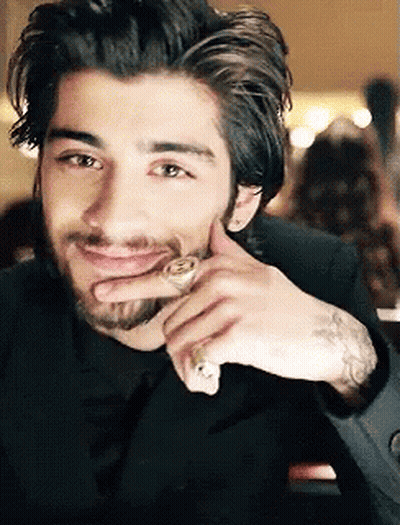 A Man With A Beard And A Ring On His Finger Smiles GIF