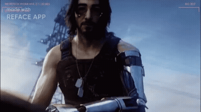 A Man With A Beard And A Robot Arm Is Standing In Front Of A Building . GIF