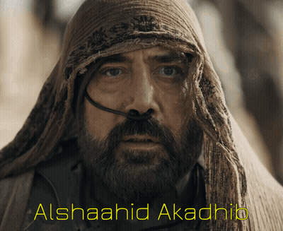 A Man With A Beard And A Scarf Around His Head Has Alshaahid Akadhib Written On The Bottom Right GIF