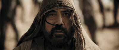 A Man With A Beard And A Scarf Around His Head Looks At The Camera GIF