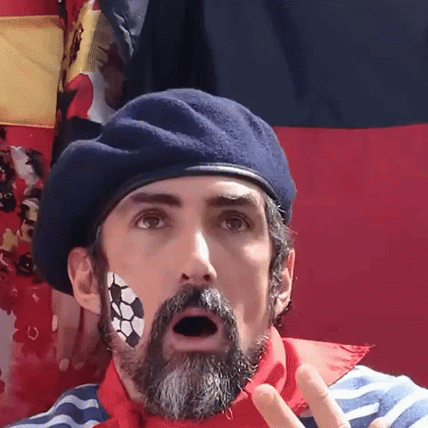 A Man With A Beard And A Soccer Ball Painted On His Face Is Wearing A Beret GIF