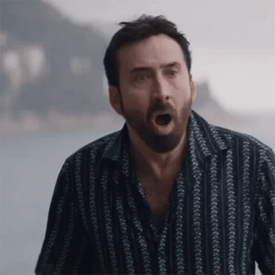A Man With A Beard And A Striped Shirt Is Making A Funny Face . GIF