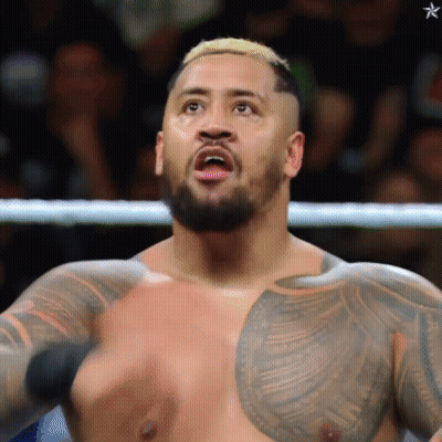 A Man With A Beard And A Tattoo On His Chest Is Standing In A Boxing Ring GIF