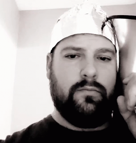A Man With A Beard And A Tin Foil Hat On His Head GIF