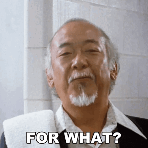 A Man With A Beard And A Towel Around His Neck Says " For What " GIF