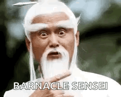 A Man With A Beard And A White Hat Is Pointing At Something . GIF