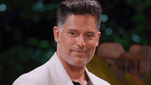 A Man With A Beard And A White Jacket Smiles For The Camera GIF