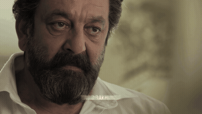 A Man With A Beard And A White Shirt Has The Word " Bak " On His Shirt GIF