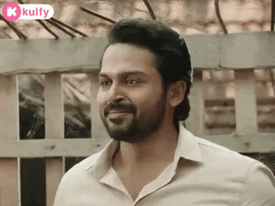 A Man With A Beard And A White Shirt Is Smiling . GIF