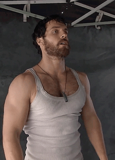 A Man With A Beard And A White Tank Top GIF