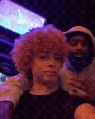 A Man With A Beard And A Woman With Curly Hair Are Posing For A Picture Together . GIF