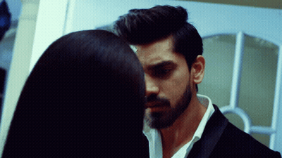 A Man With A Beard And A Woman With Long Hair Are Looking Into Each Other 'S Eyes GIF