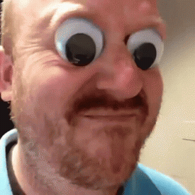A Man With A Beard And Big Googly Eyes Is Making A Face . GIF