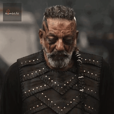 A Man With A Beard And Black Paint On His Face Is Wearing A Black Vest With Studs On It GIF