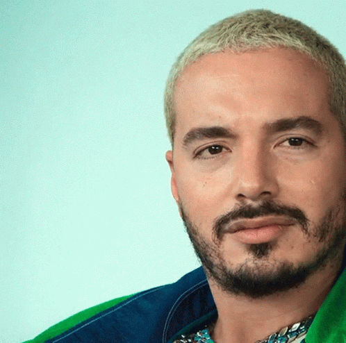 A Man With A Beard And Blonde Hair Is Wearing A Blue And Green Jacket GIF