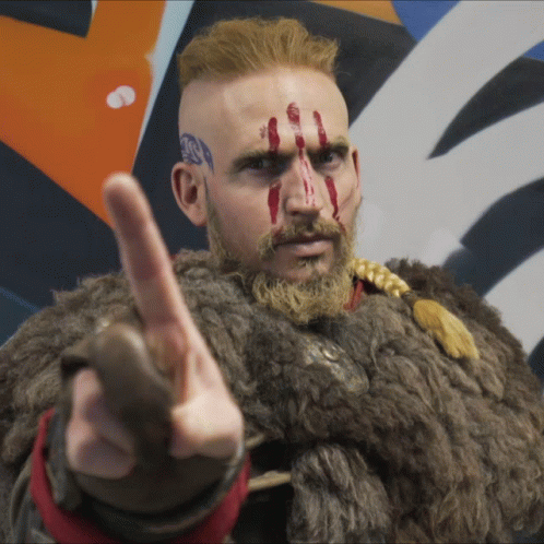 A Man With A Beard And Blood On His Face Points His Finger GIF