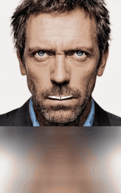 A Man With A Beard And Blue Eyes Is Looking At The Camera GIF