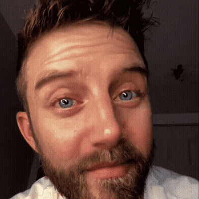 A Man With A Beard And Blue Eyes Is Making A Face GIF