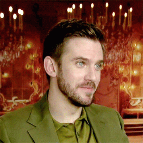 A Man With A Beard And Blue Eyes Is Wearing A Green Jacket GIF