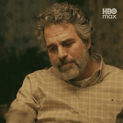 A Man With A Beard And Curly Hair Is Wearing A Plaid Shirt With Hbo Max On The Bottom GIF