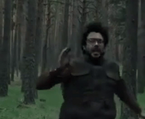 A Man With A Beard And Glasses Is Crying With His Mouth Wide Open . GIF