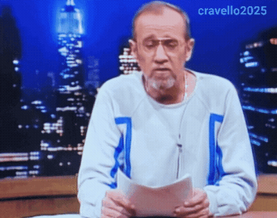 A Man With A Beard And Glasses Is Holding A Piece Of Paper In Front Of A City Skyline .. GIF