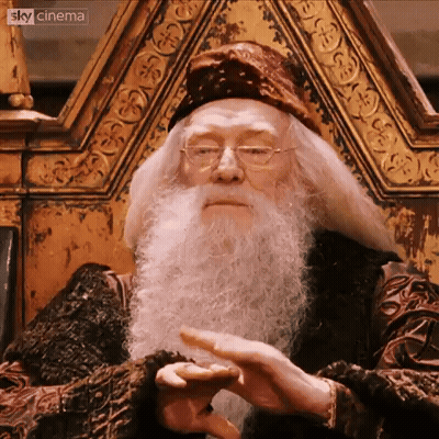 A Man With A Beard And Glasses Is Sitting In A Chair With Sky Cinema Written In The Corner GIF