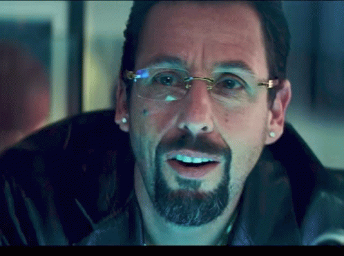 A Man With A Beard And Glasses Is Smiling GIF