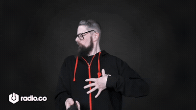 A Man With A Beard And Glasses Is Wearing A Black Hoodie With The Word Radio.co On It GIF