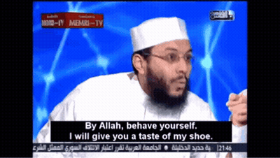 A Man With A Beard And Glasses Says By Allah Behave Yourself I Will Give You A Taste Of My Shoe .. GIF