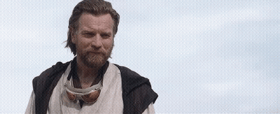 A Man With A Beard And Goggles Is Standing In Front Of A Cloudy Sky And Saying `` Hello There '' . GIF