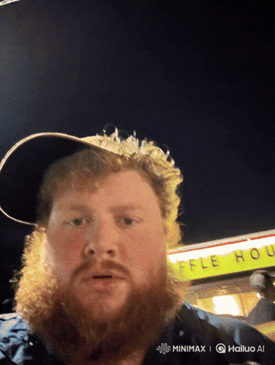A Man With A Beard And Hat Stands In Front Of A Waffle House GIF