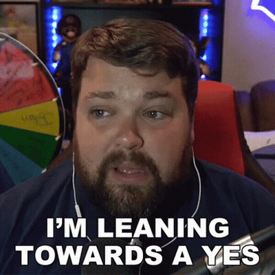 A Man With A Beard And Headphones Is Leaning Towards A Yes . GIF