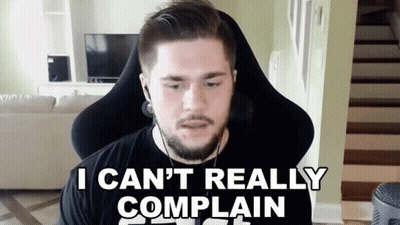 A Man With A Beard And Headphones Is Sitting In A Chair And Saying " I Can 'T Really Complain " GIF