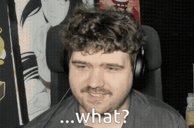A Man With A Beard And Headphones Is Smiling And Asking What GIF