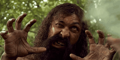 A Man With A Beard And Long Hair Is Making A Funny Face GIF