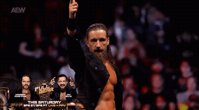 A Man With A Beard And Long Hair Is Standing In Front Of A Crowd With His Arms In The Air . GIF