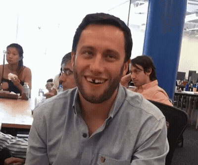 A Man With A Beard And Missing Teeth Is Smiling GIF